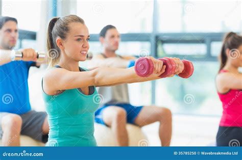 People Lifting Dumbbell Weights in the Gym Stock Photo - Image of body, caucasian: 35785250