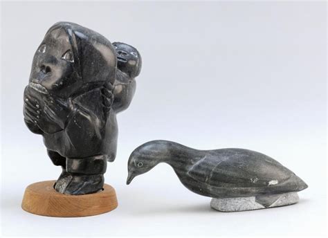 Lot - TWO INUIT ESKIMO SOAPSTONE CARVINGS Woman with Papoose on wood base carved of black ...