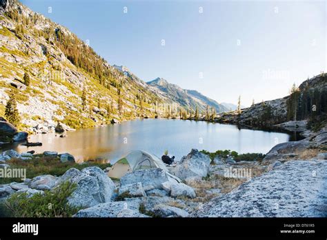 Young man camping at remote lake, Trinity Alps, California, USA Stock Photo - Alamy