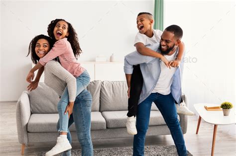 Portrait of a happy black family having fun at home Stock Photo by Prostock-studio