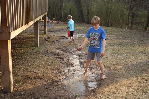 Child Barefoot In Mud