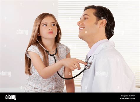 Girl listening to the heartbeat of a doctor with a stethoscope Stock ...