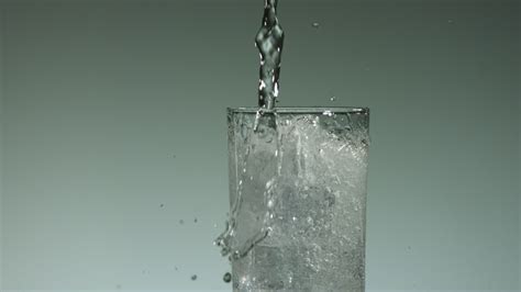 Water in slow motion pouring into glass - Free Stock Video