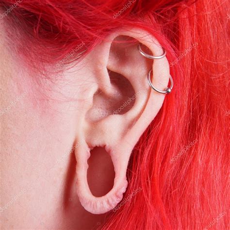 Pics: ear gauges | Stretched ear lobe piercing — Stock Photo © buecax ...