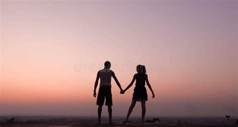 Silhouette of Couple Holding Hand at Sunset Stock Image - Image of female, couple: 137495275