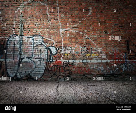 Graffiti on the old wall of red brick Stock Photo - Alamy