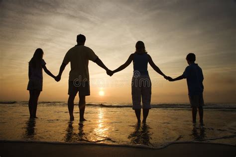 Family Holding Hands on Beach Watching the Sunset Stock Image - Image ...