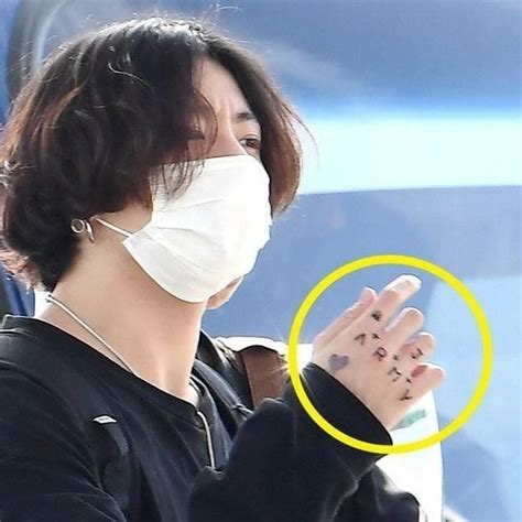 Jungkook spotted with a new tattoo on his hand that spells out 'ARMY' | allkpop