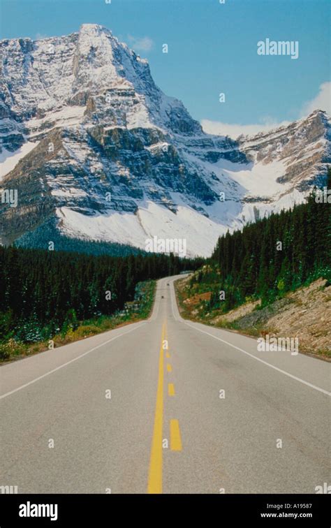 Road leading into mountains Stock Photo - Alamy