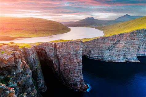 Sorvagsvatn Lake Cliffs Over the Ocean with Tiny Tourists Stock Photo ...