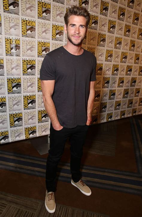 Liam Hemsworth shares a smile at the #MockingjayPart2 press line. # ...