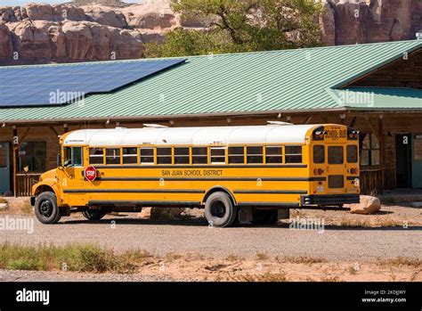 School Bus Parked By Building With Solar Panels On Roof Stock Photo - Alamy