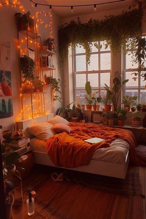 an aesthetic orange warm boho bedroom. orange throw blanket on bed with ...