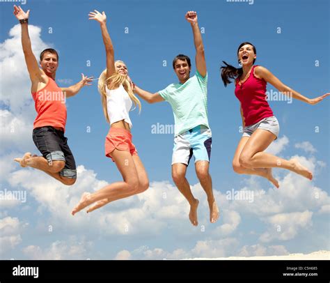 Portrait of four jumping happy people Stock Photo - Alamy