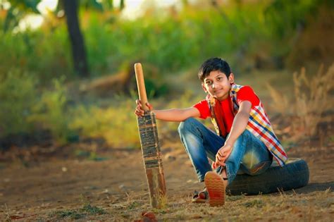 Premium Photo | Rural indian child playing cricket