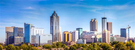 Downtown Atlanta Skyline showing several prominent buildings and hotels under a blue sky ...