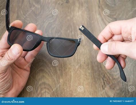 Broken Sun Glasses in the Hands Stock Image - Image of repair, ground: 76024657