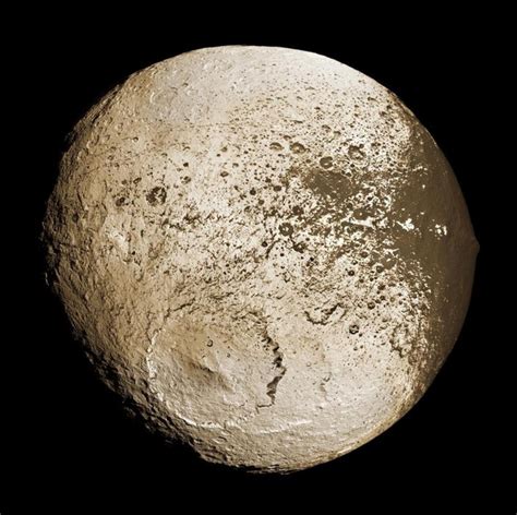 Iapetus, the third largest of the more than 60 moons of Saturn, with ...