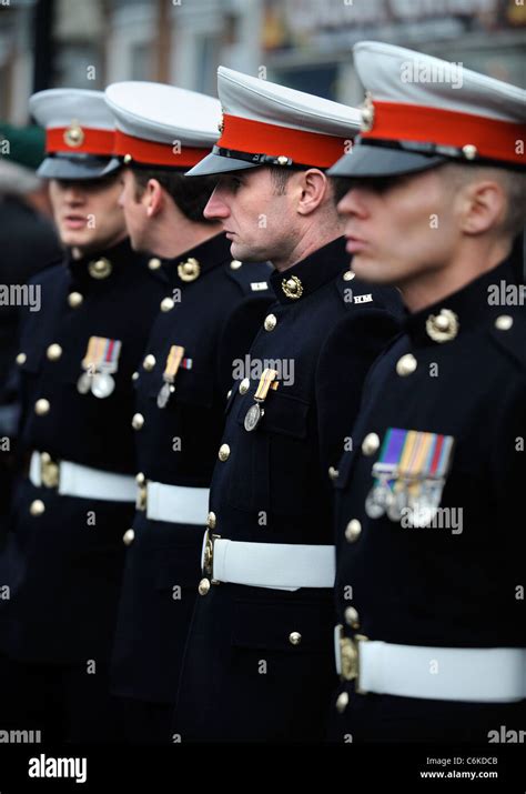 Royal Marines in dress uniform amongst mourners gathered for a repatriation ceremony at Wootton ...