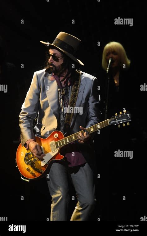 Guitarist Mike Campbell is shown performing on stage during a "live ...