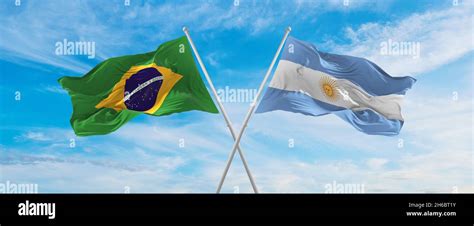 crossed national flags of Brazil and Argentina flag waving in the wind ...