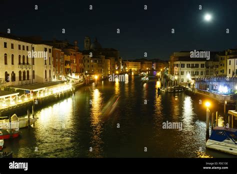 Grand Canal night view with light reflection on water and ships ...