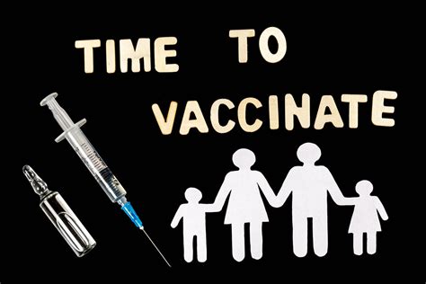 Vaccination time text on black with white family silhouette, syringe and ampoule - Creative ...