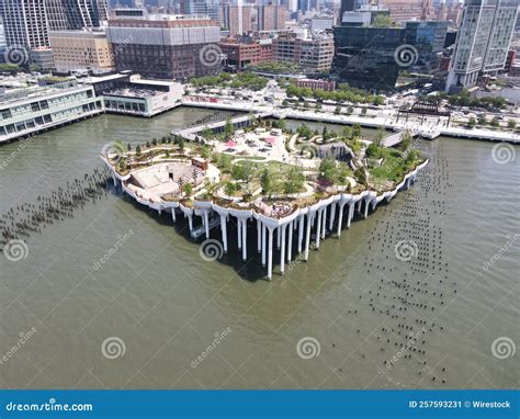 Aerial Shot of the Little Island Park in New York Over Water with Buildings in the Background ...