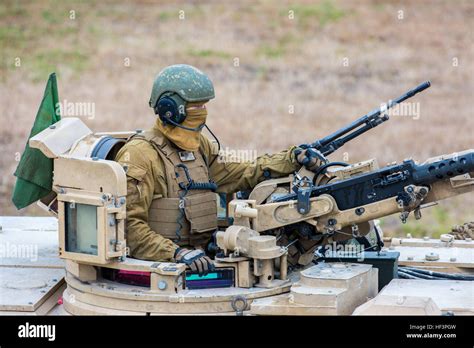 A U.S. Marine Corps tank crewman with Company B, 2nd Tank Battalion, mans a turret on an M1A1 ...