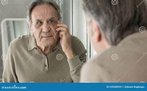 Old Man Looks at the Wrinkles Around the Eyes in the Mirror Stock Image ...