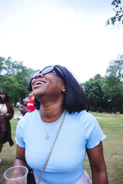 Young Woman Laughing in a Park · Free Stock Photo