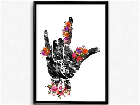 a black and white photo with flowers in the shape of a hand holding up ...