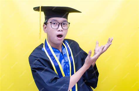 Premium Photo | Shocked and surprised asian young man shouts happily to ...