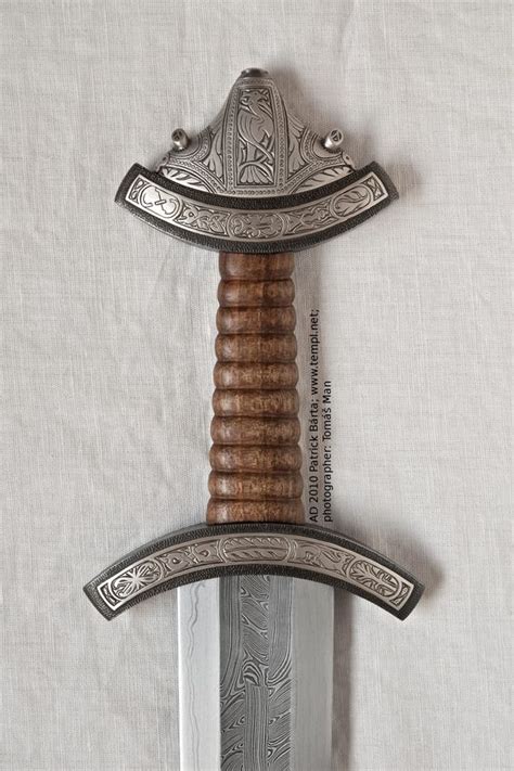 Saxon Sword upright, hilt iron decorated with engraved silver inlay. 10th Century. Abingdon, UK ...