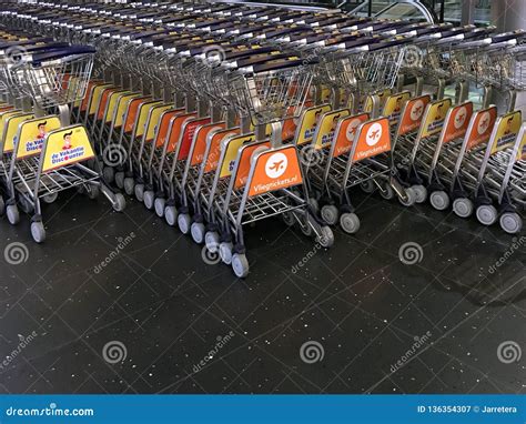 Airport luggage trolleys editorial photography. Image of equipment - 136354307