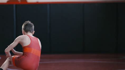 Premium stock video - Teenage wrestler working on his stance and motion drills during practice