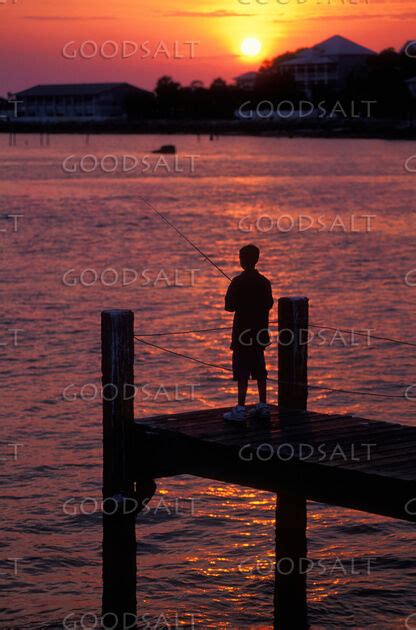 Boy Fishing at Sunset - GoodSalt