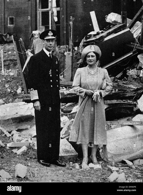 King George V and Queen Elizabeth, stand in the ruins of Buckingham Palace after an air raid in ...