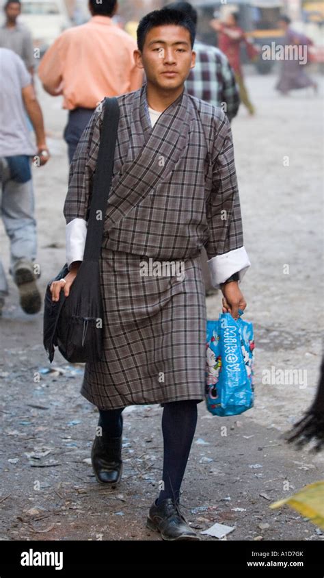 A Bhutanese man in traditional clothes on the street in Jaigon West ...