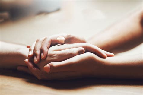 Shot of two people holding hands in comfort – ERNST MÜLLER GmbH