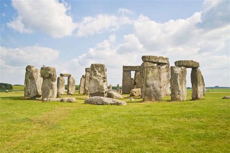 stonehenge standing in the middle of a grassy field