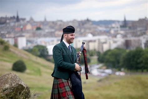 Scottish Bagpiper Playing Music with Bagpipe at Edinburgh in Scotland ...