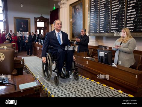 Texas Gov. Greg Abbott rolls his wheelchair up ramp to dais in the ...