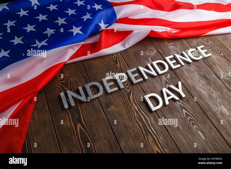 the words independence day laid on brown wooden planks surface with ...