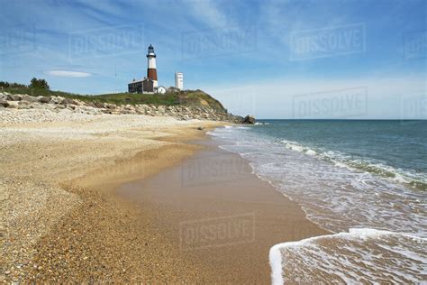 Beach with lighthouse in background - Stock Photo - Dissolve