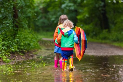 Kids Playing in the Rain with Umbrella Stock Image - Image of rainbow ...