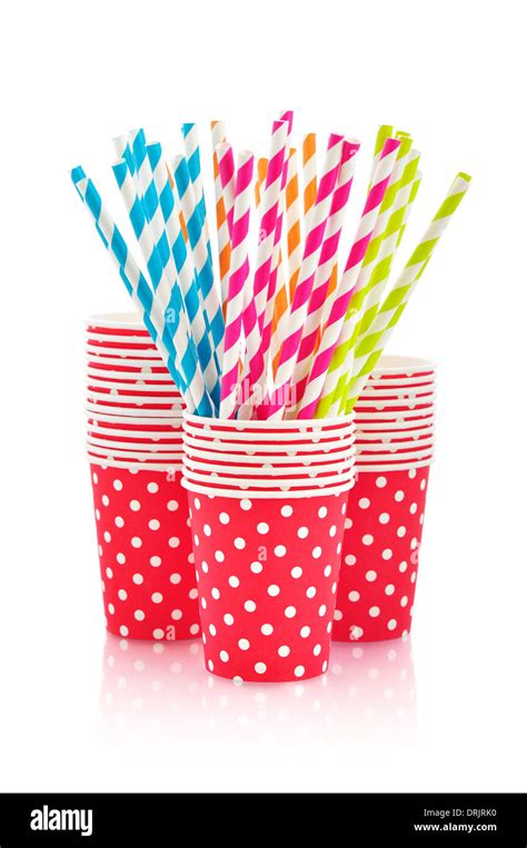 Colorful paper cups and striped straws for birthday party isolated on ...