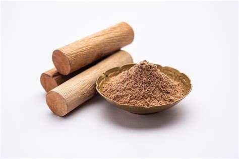 Chandan or sandalwood powder with sticks, perfume or oil which retain ...