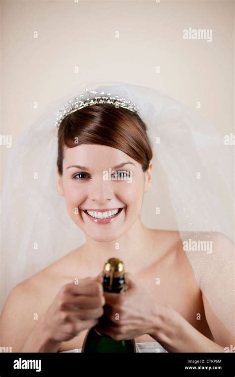Una joven novia abrir una botella de champán Fotografía de stock - Alamy