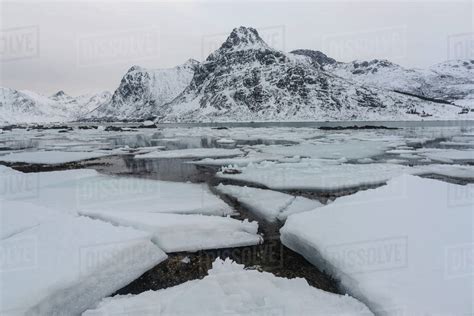 Cracked ice and snow covered mountains, Lofoten Islands, Nordland ...